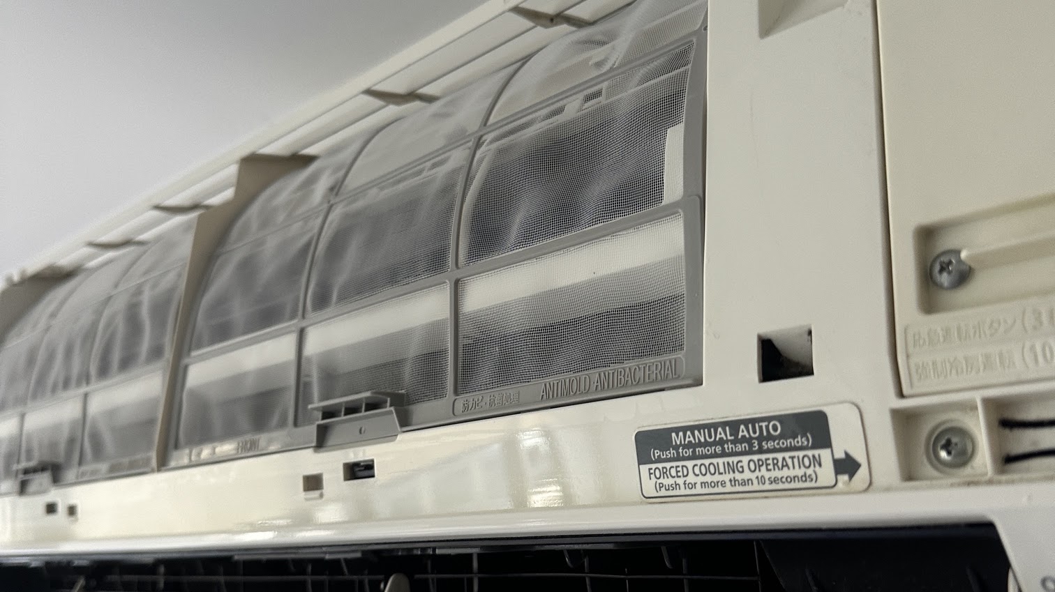 Clean internal filters inside a wall mounted split system air conditioner