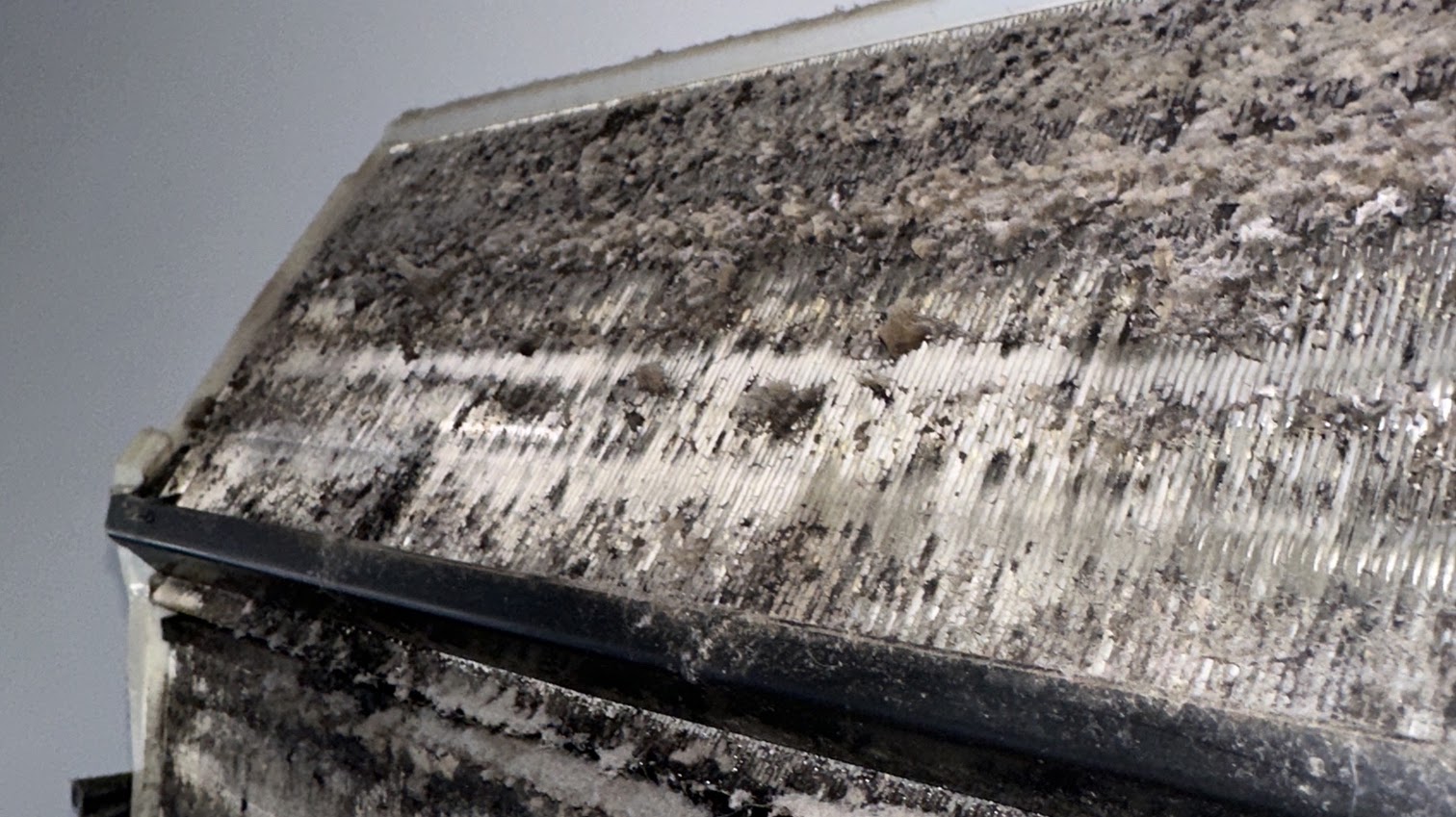 Heavy dirt and buildup inside a split system air conditioner before cleaning